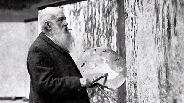 Claude Monet at his canvas.